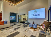 Thumbnail 31 of 36 - A living room with a couch, chairs, and a TV displaying the word "TRAVIS".