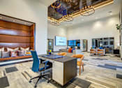 Thumbnail 24 of 36 - A modern office space with a reception area, desks, and chairs.
