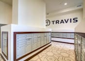 Thumbnail 36 of 36 - A Travis sign is on the wall above a row of lockers.