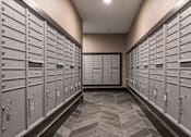 Thumbnail 14 of 30 - A long hallway with a row of lockers on each side.