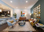 Thumbnail 9 of 30 - A modern living room with a grey sofa, yellow armchair, and a coffee table.