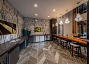 Thumbnail 2 of 30 - A modern bar with a marble patterned wall and wooden stools.