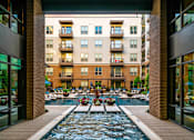 Thumbnail 24 of 30 - A long rectangular pool with a fountain in the middle.