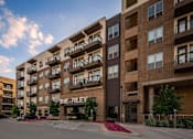 Thumbnail 27 of 30 - The Riley apartment complex is shown in the image.
