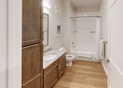 Thumbnail 13 of 27 - Bathroom with a toilet and a sink and a shower at The Landing Apartments, Indiana