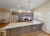 Thumbnail 15 of 27 - Kitchen with a large peninsula and a large window at The Landing Apartments, Indiana