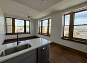 Thumbnail 4 of 14 - A kitchen with a sink and a window.