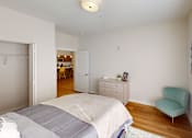 Thumbnail 8 of 27 - Bedroom with a bed and a chair and a closet  at The Landing Apartments, Indianapolis