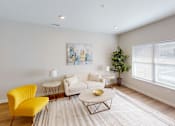 Thumbnail 3 of 27 - Living room with a white couch and yellow chairs  at The Landing Apartments, Indianapolis, Indiana