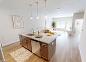 Thumbnail 2 of 27 - Open kitchen and living room with a dining room table  at The Landing Apartments, Indiana, 46234