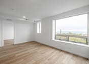 Thumbnail 20 of 25 - A room with a large window overlooking the ocean.