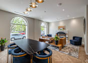 Thumbnail 3 of 25 - A modern dining room with a large table and chairs.