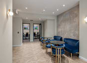 Thumbnail 4 of 25 - A room with blue chairs and a patterned wallpaper.