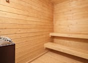 Thumbnail 28 of 70 - A wooden sauna with benches and a table.