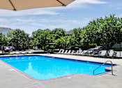 Thumbnail 9 of 46 - A large outdoor swimming pool surrounded by trees and lounge chairs. at Standing Bear Lake, Nebraska, 68164