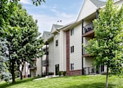 Thumbnail 7 of 70 - Apartment building with balconies and trees in front. at The Pointe, LaVista, NE