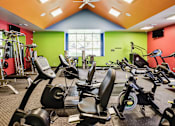 Thumbnail 37 of 70 - A gym with a variety of exercise equipment including treadmills, stationary bikes, and weight machines. at The Pointe, LaVista, NE, 68128