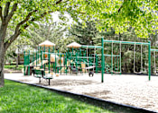 Thumbnail 18 of 70 - A playground with a green swing set and a yellow slide. at The Pointe, Nebraska, 68128