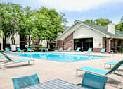 Thumbnail 27 of 70 - A pool with lounge chairs and a building in the background. at The Pointe, LaVista, Nebraska