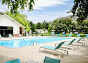 Thumbnail 26 of 70 - A pool with sun loungers and a building in the background. at The Pointe, LaVista, NE, 68128