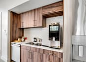 Thumbnail 25 of 36 - A modern kitchen with wooden cabinets and stainless steel appliances.