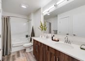 Thumbnail 5 of 36 - A bathroom with a white sink and a white toilet.
