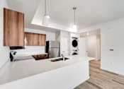 Thumbnail 4 of 36 - A modern kitchen with wooden cabinets and stainless steel appliances.