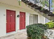 Thumbnail 76 of 133 - A white house with red doors numbered 12 and 11.