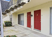 Thumbnail 71 of 133 - A white house with red doors numbered 9 and 10.