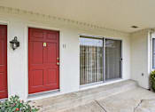 Thumbnail 93 of 133 - A red door with a black lantern above it is on the left.