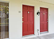 Thumbnail 52 of 133 - Two red doors on a white building with the numbers 10 and 9 on the wall.