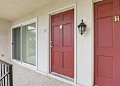 Thumbnail 112 of 133 - A red door with a black lantern on the wall.