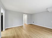 Thumbnail 64 of 133 - A room with wooden flooring and white walls.