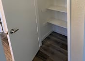Thumbnail 20 of 43 - A white pantry with a door open.