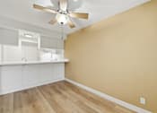 Thumbnail 98 of 133 - A room with a ceiling fan and wooden flooring.