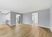 Thumbnail 56 of 133 - A room with wooden floors and white walls.