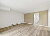 Thumbnail 91 of 133 - A room with wooden flooring and white walls.