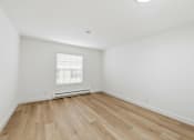 Thumbnail 96 of 133 - A room with wooden flooring and a window with blinds.