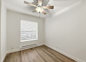 Thumbnail 116 of 133 - A room with a ceiling fan and a window with blinds.
