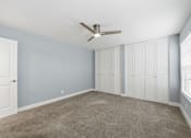 Thumbnail 61 of 133 - A room with a ceiling fan and a door.