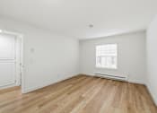 Thumbnail 102 of 133 - A room with wooden floors and white walls.