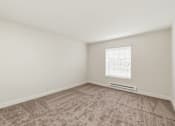 Thumbnail 109 of 133 - A room with a carpeted floor and a window with blinds.