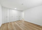 Thumbnail 78 of 133 - Closet with white doors and wooden floor.