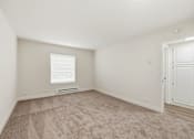 Thumbnail 125 of 133 - A room with a carpeted floor and a window with blinds.