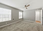 Thumbnail 55 of 133 - A room with a ceiling fan and a door.