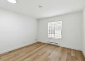 Thumbnail 97 of 133 - A room with wooden flooring and a window with blinds.