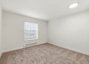 Thumbnail 123 of 133 - A room with a window and a carpeted floor.