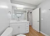 Thumbnail 74 of 133 - A white bathroom with a toilet, sink, and bathtub.