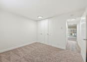 Thumbnail 128 of 133 - A room with white walls and a carpeted floor.