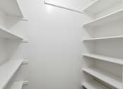 Thumbnail 103 of 133 - Empty white shelves in a room.